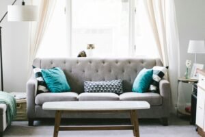 grey sofa with blue cushions in living room