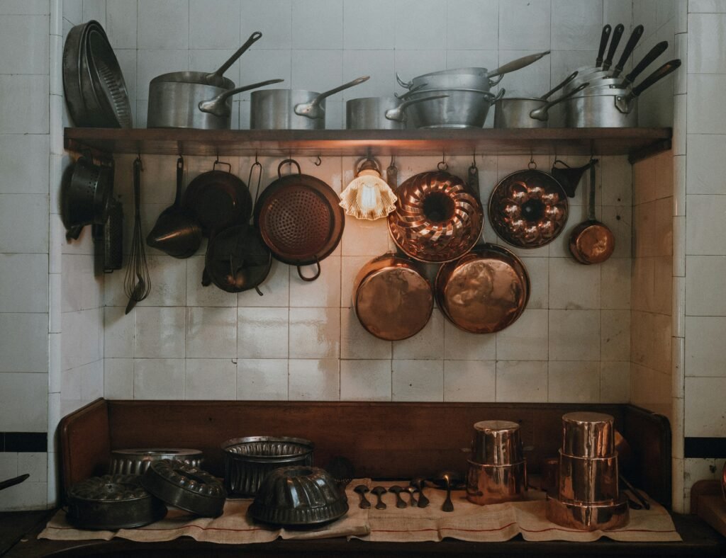 cooking utensils on open shelf and hanging hooks